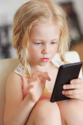 beautiful little girl playing game or watching video on smartphone mobile